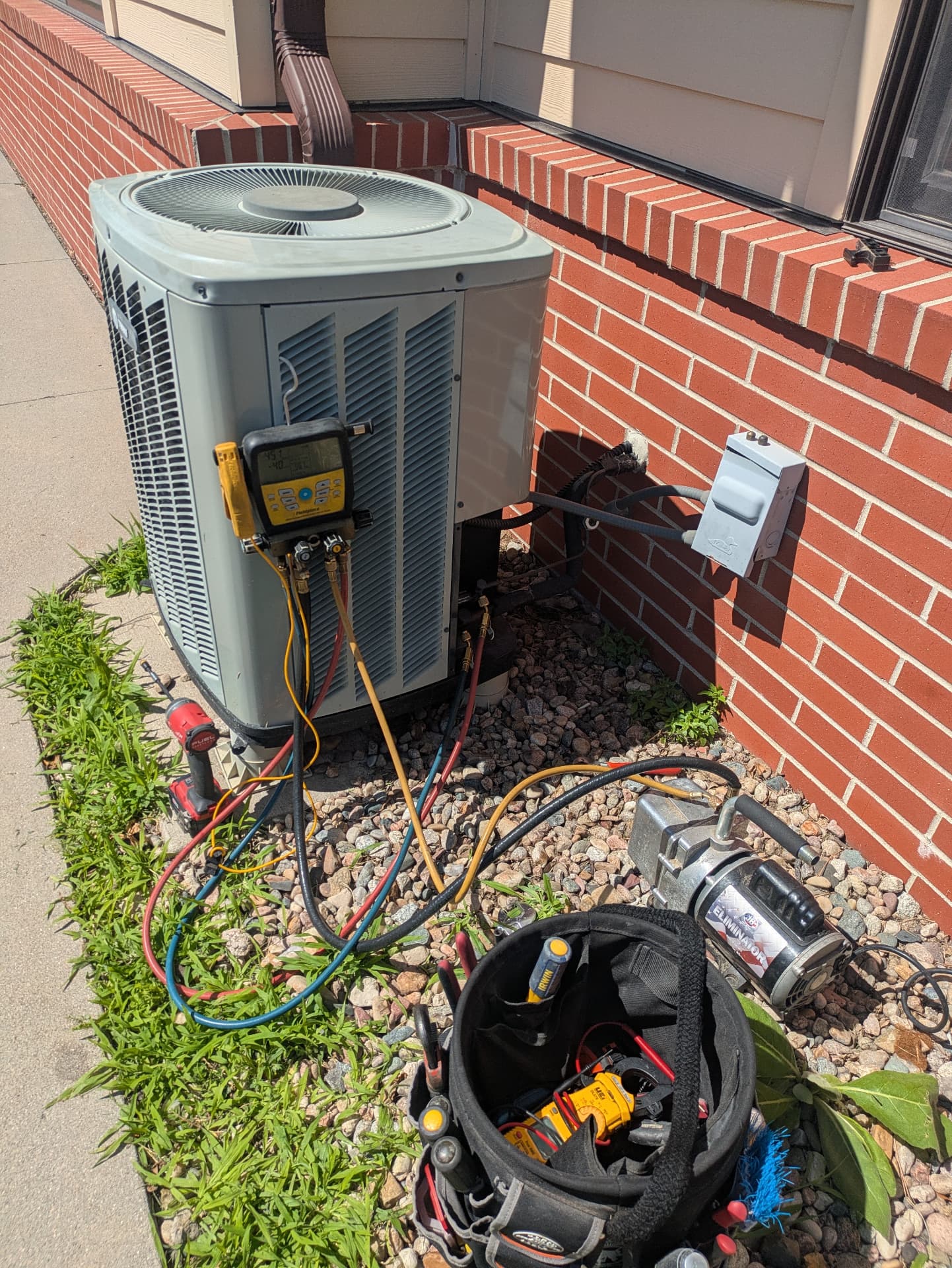Residential outdoor air conditioner connected to Bruno HVAC diagnostic equipment