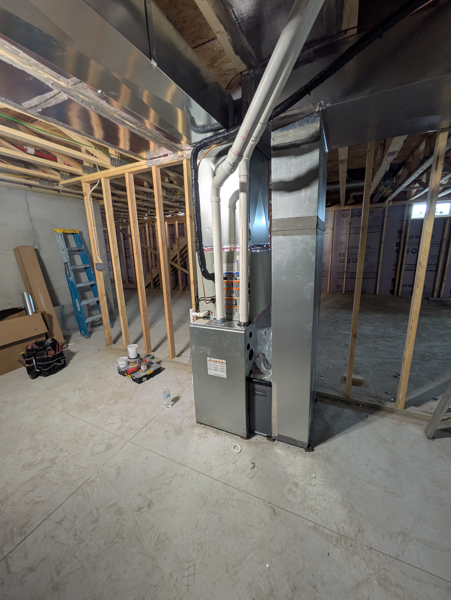 New furnace and ductwork installed by Bruno HVAC in a basement under construction