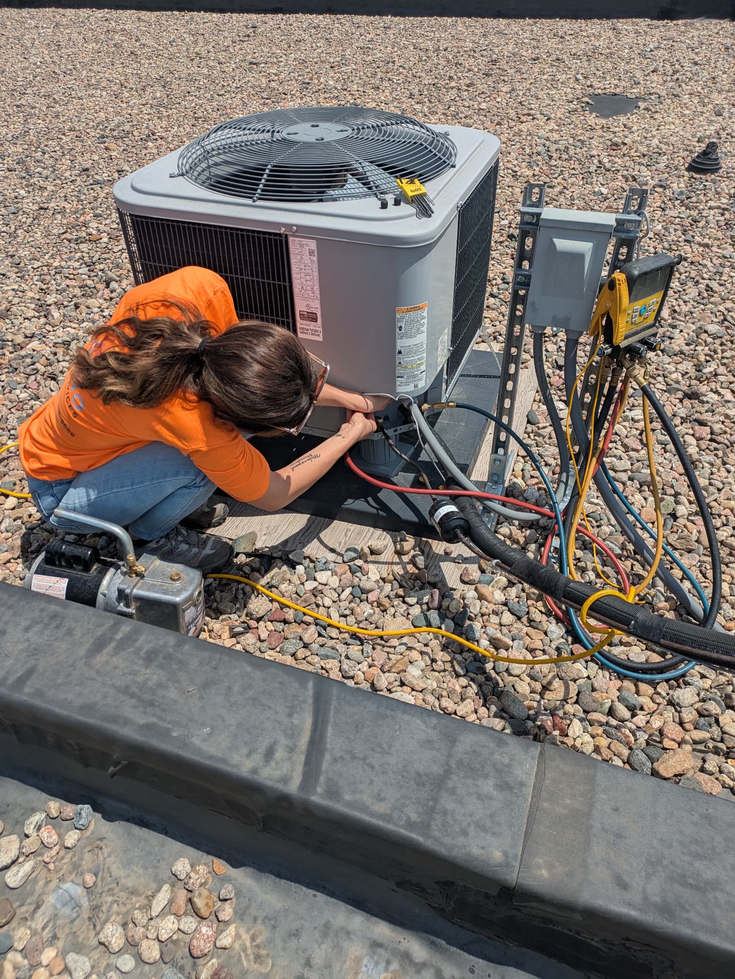 Bruno HVAC technician servicing a rooftop air conditioning unit